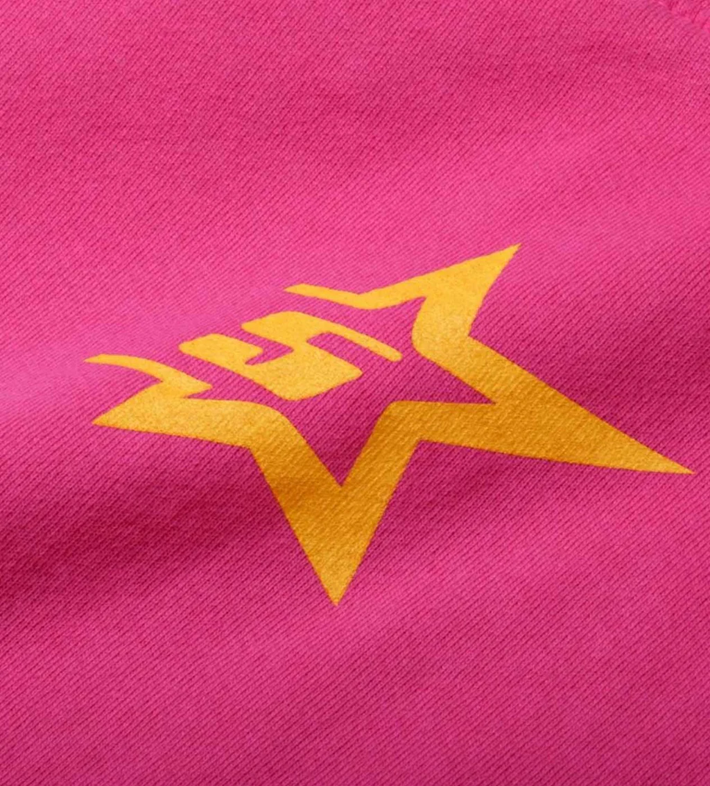 Macro close-up of hot pink Sp5der fleece showing the woven surface texture and a yellow printed star logo