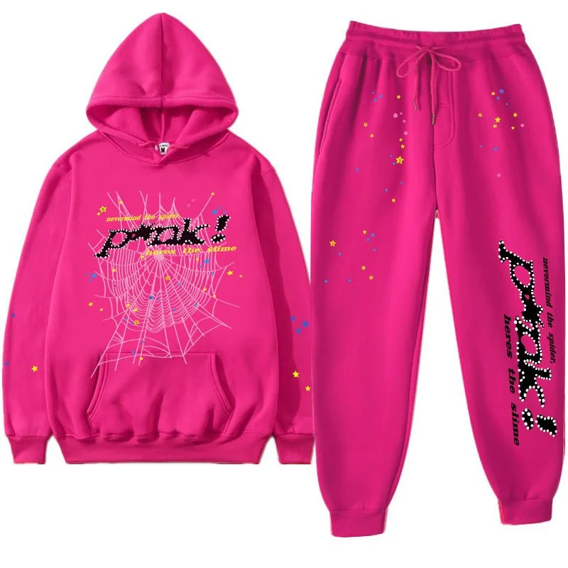 Hot magenta Sp5der P*NK sweatsuit laid flat, hoodie with a black studded P*NK logo and white web on the chest beside matching magenta sweatpants with the same studded logo running down the leg