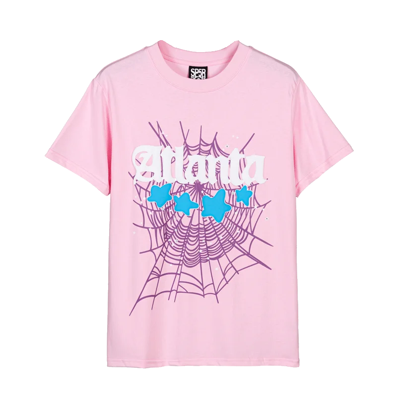 Pale pink Sp5der Atlanta t-shirt laid flat with white gothic Atlanta lettering, four light blue puff stars and a lilac spider web printed across the front